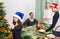 Cheerful positive smiling family setting table for dinner