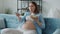 Cheerful pregnant woman enjoying meal fresh salad and watching TV at home