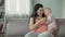 Cheerful pregnant woman hugging cute little baby girl, love and tenderness