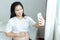 Cheerful pregnant young Asians woman sitting on bed and taking selfie with mobile phone