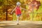 Cheerful preschooler girl at famous Ochre path through large ochre deposits in Roussillon, Provence, France