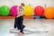 Cheerful preschooler girl teaches the element of dance in the gym. The concept of sports, education, hobbies, training and dance