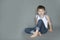 Cheerful preschooler sitting on the floor.