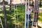 Cheerful preteen boy posing while climbing at rope park