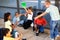 Cheerful preteens resting outdoors in schoolyard during break