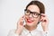 Cheerful pretty business woman in glasses talking on cell phone