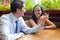 Cheerful pretty couple at restaurant table