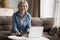 Cheerful pretty senior pensioner woman using laptop