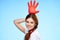 cheerful pretty woman holding an inflated rubber glove above her head cleaning