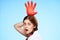 cheerful pretty woman holding an inflated rubber glove above her head cleaning