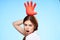 cheerful pretty woman holding an inflated rubber glove above her head cleaning