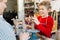 Cheerful pupil smiling broadly while modeling clay figures