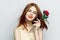cheerful red-haired woman holding flower rose reborn charm model isolated background