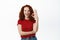 Cheerful redhead woman with curly hair showing OK sign, winking and smiling, say yes, encourage to buy something, make