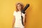 cheerful redhead woman photographer with camera in straw hat making photo, cameraman