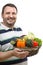 Cheerful retailer with a basket of vegetables