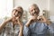 Cheerful retired couple in love showing finger heart shaped hands