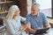 Cheerful retired loving couple resting at home