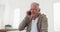 Cheerful retired senior man talking on mobile phone while sitting at home