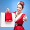 Cheerful retro girl holding shopping bags