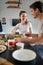 Cheerful romantic cople having breakfast together