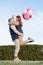 cheerful romantic couple dating outdoors with balloons