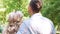 Cheerful romantic couple enjoying date in park, laughing and hugging, slow-mo