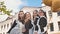 Cheerful Russian girls graduating with orange balloons on the last school day.