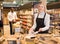 Cheerful saleswoman offering bulk foods