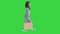 Cheerful school girl walking with shopping bags on a Green Screen, Chroma Key.