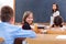 Cheerful schoolgirl in class room