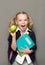 Cheerful schoolgirl with copybooks and apple .