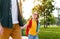 Cheerful schoolgirl walking to school with father