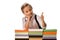 cheerful schoolkid showing thumb up near colorful books isolated on white.