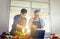 Cheerful senior asian father and middle aged son cooking together at kitchen, Happiness asian family concepts