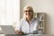 Cheerful senior business woman in elegant glasses posing for portrait