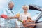 Cheerful senior couple happy for buying fresh vegetables from the hypermarket