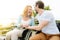 Cheerful senior couple sititng in the wheelchairs outdoors