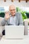 Cheerful Senior Man Video Chatting On Laptop