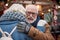 Cheerful senior married couple embracing outdoor