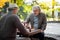 Cheerful senior men playing chess together outdoor