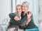 Cheerful senior mother hugging grownup daughter. Loving caucasian mom hugging her daughter while sitting together at