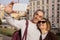 Cheerful Senior Spouses Making Selfie On Cellphone Standing Outside
