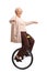 Cheerful senior woman riding a unicycle and balancing with hands