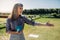 Cheerful senior woman standing in a lawn holding a boule