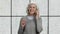 Cheerful senior woman talking on transparent phone.