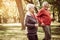 Cheerful seniors couple exercising in park.