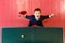 Cheerful seven-year-old child enjoys winning table tennis, top view