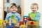 Cheerful sibling playing in blocks