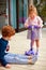 Cheerful siblings having fun, playing on the patio at home